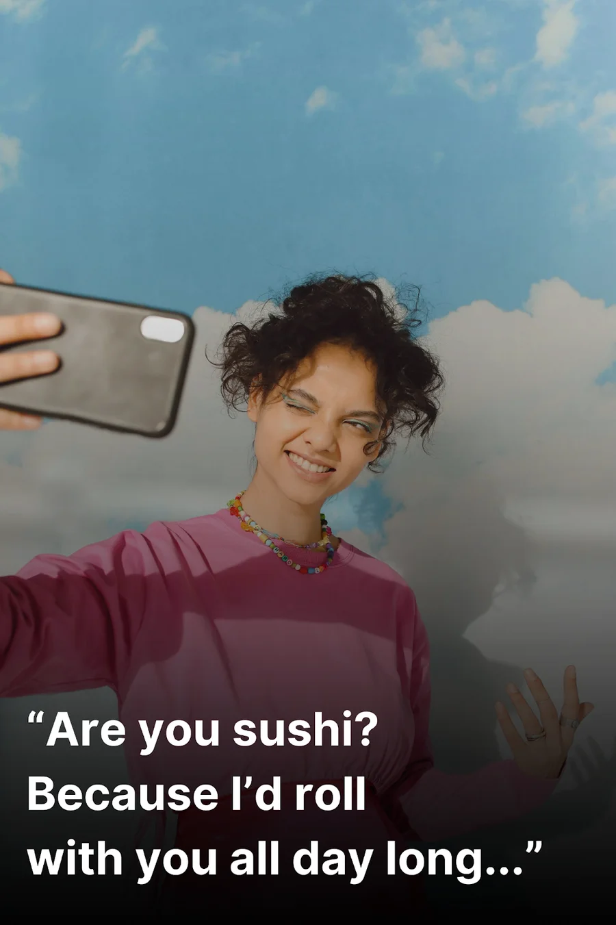 Young woman taking a selfie after hearing a clever Tinder pick up line.