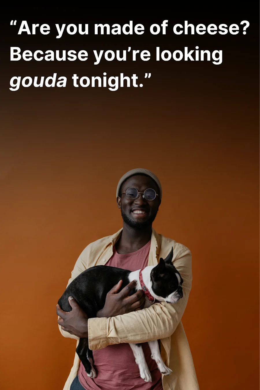 Young man with a dog on his lap laughing after hearing a funny pick up line